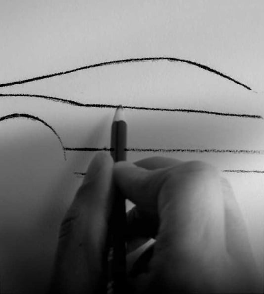 Hand and pencil drawing a sketch for an Acura Model Hand and pencil drawing a sketch for an Acura Model